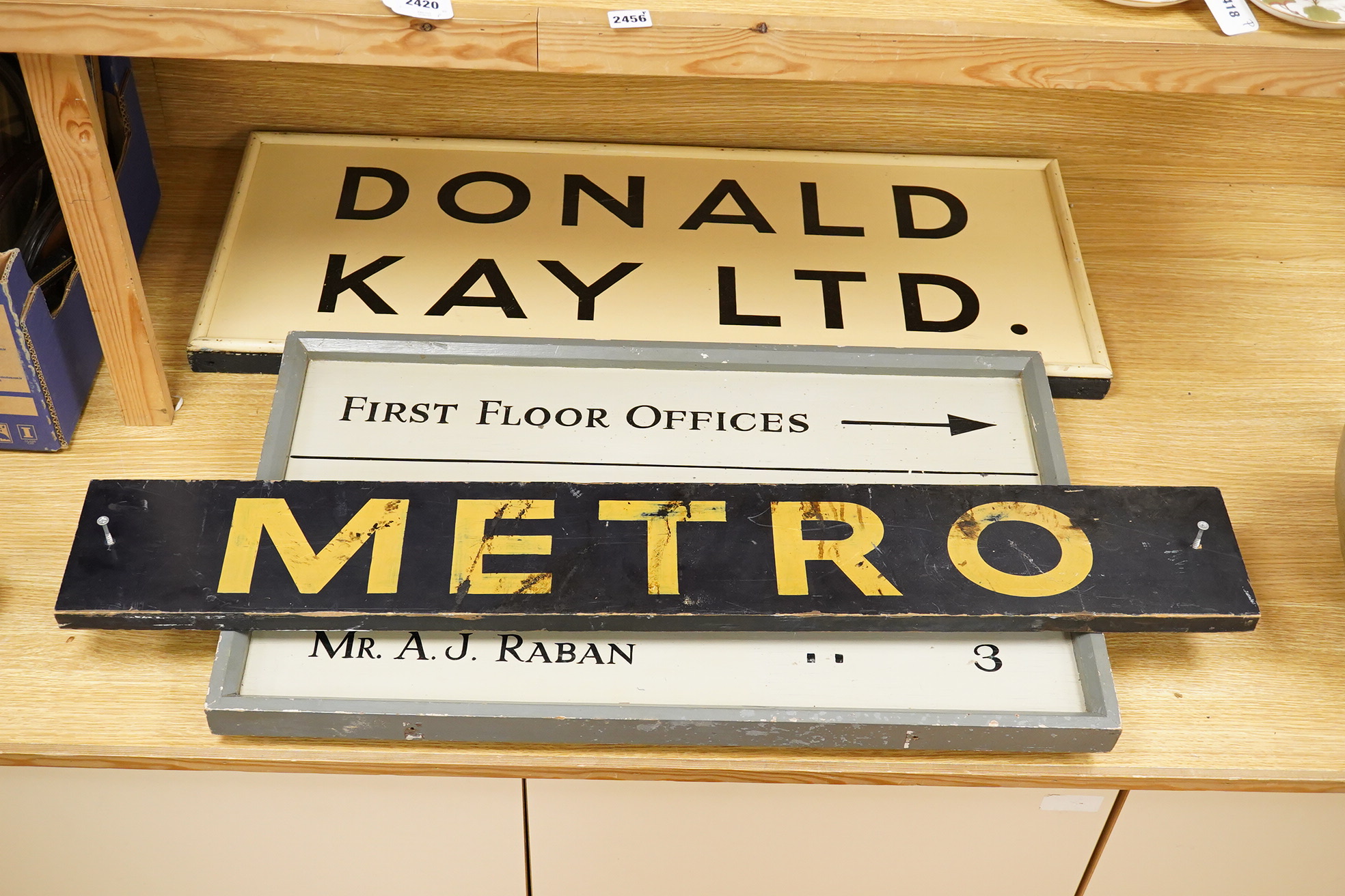 Three wooden signs, one a Metro sign, another First Floor offices, the other Donald Kay Ltd. Metro- 98cm